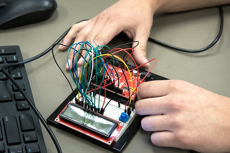 student with electronics