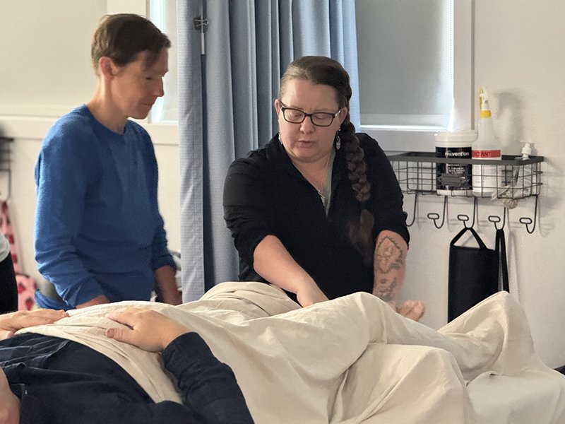 massage student with instructor