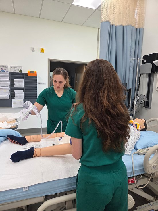 students working with dummy patient